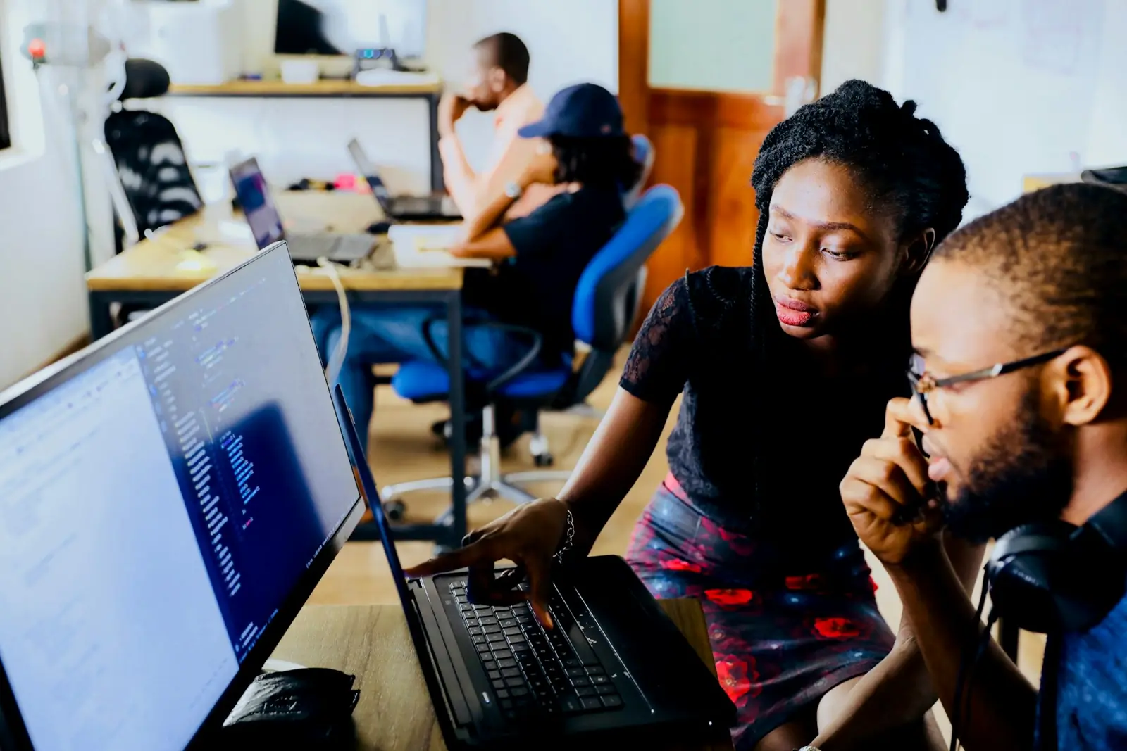 Two engineers pairing at a laptop