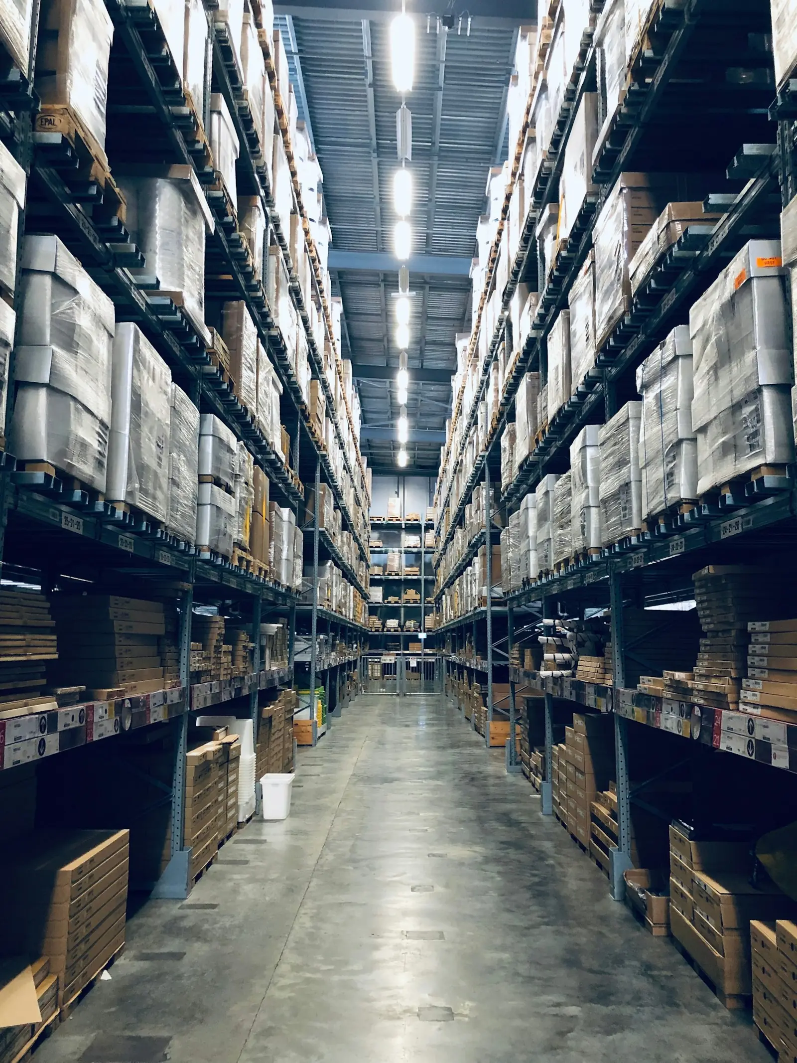 Long warehouse aisle with racked inventory